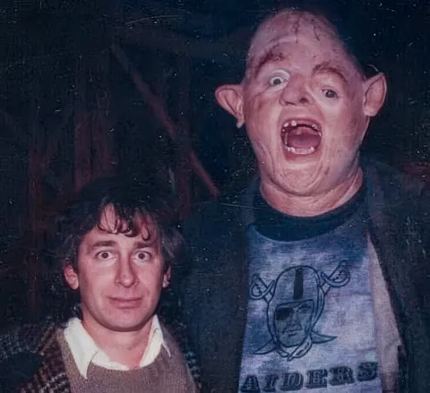 Steven Spielberg and John Matuszak as Sloth behind the scenes of The Goonies (1985)