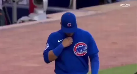 Brothers Willson and William Contreras exchange lineup cards before a game