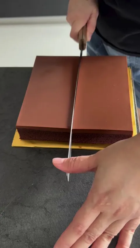 Cutting a moist chocolate cake