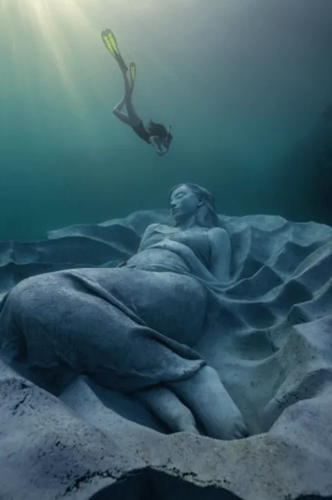 "Ocean Gaia", Japan's first underwater sculpture, weighing over 45 tons and 5.5 meters wide, created by British sculptor Jason deCaires Taylor, featuring Japanese model Kiko Mizuhara, resting 5 meters below the surface off the island of Tokunoshima, Japan, installed on October 14, 2025