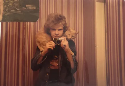 My dad and his cat Simon (as in Garfunkel). Ontario, Canada. 1980s.