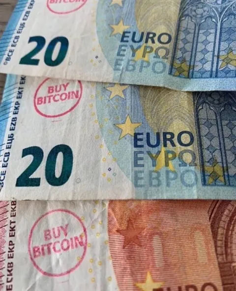 People have started stamping “buy bitcoin” on paper money in Europe