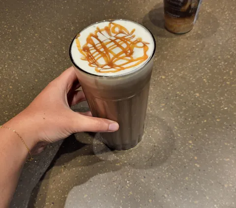 To reduce plastic waste, customers sitting at this Starbucks store get reusable glass cups.