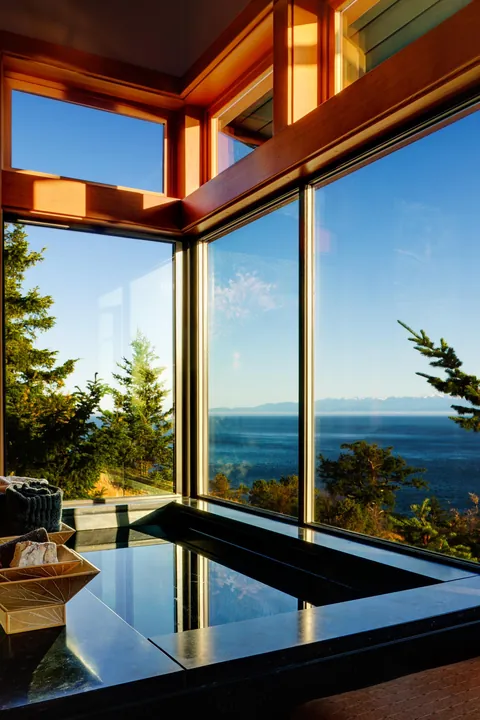 Marble bath with floor to ceiling windows overlooking the scenic ocean around San Juan Islands, Washington [2000×3001]