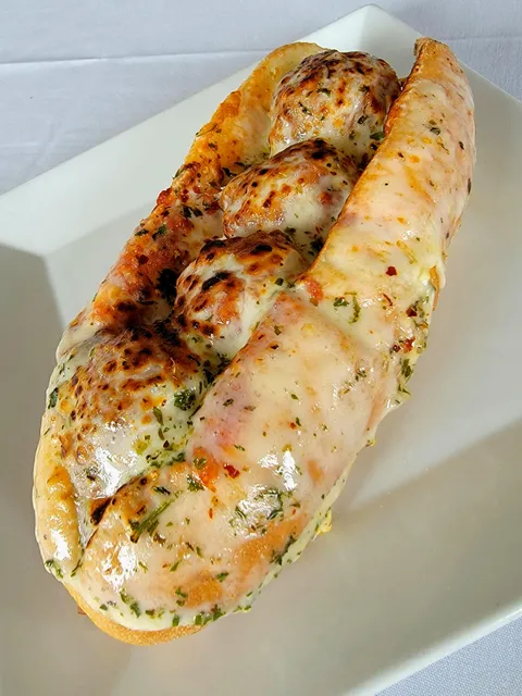 Meatball parmesan sub with toasted garlic bread as the roll