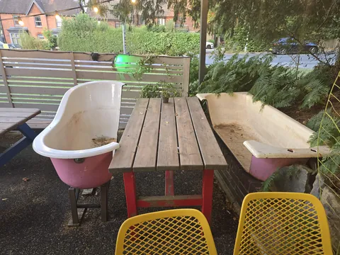 Small restaurant I went to had a table with cutout bathtubs for seats.