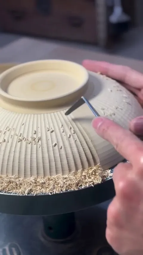 Carving lines in pottery