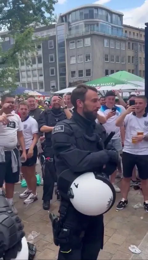 England fans serenading a Southgate doppelgänger/German police officer 