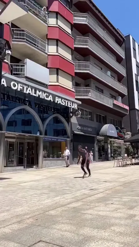 A man performs a flip while seeming to walk on air.