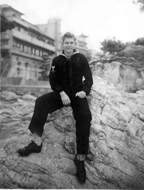 My 16 year old great grandfather sitting in Tokyo Bay, Japan towards the end of WWII. This man lied on his birth certificate to get into the Navy at the age of 15. He's a different breed.