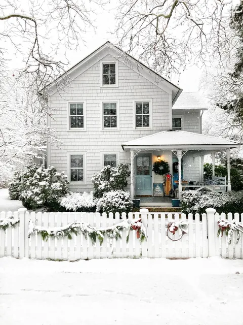 Shingle style house in the snow, Amagansett, Long Island, New York.