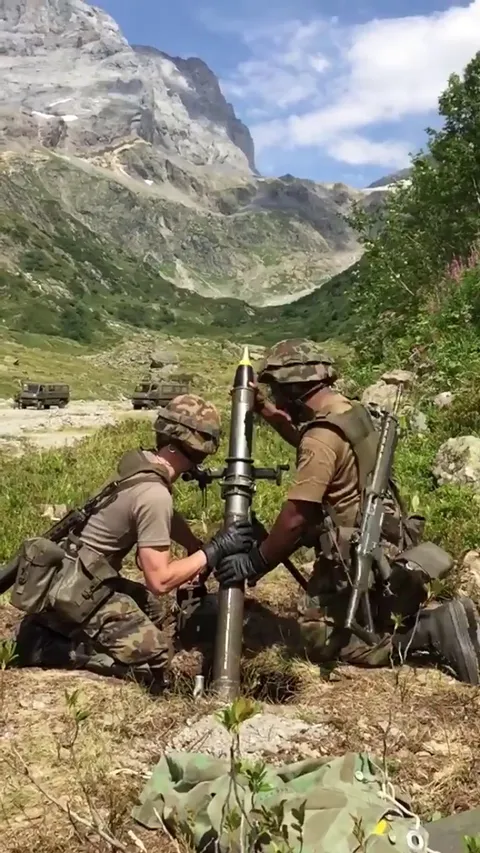 Slow-mo shot of a Swiss soldier firing a mortar