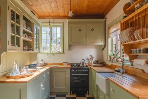 Kitchen with garden facing windows in a 19th-century Arts and Crafts residence, Port Sunlight, Merseyside, England [1600x1067]