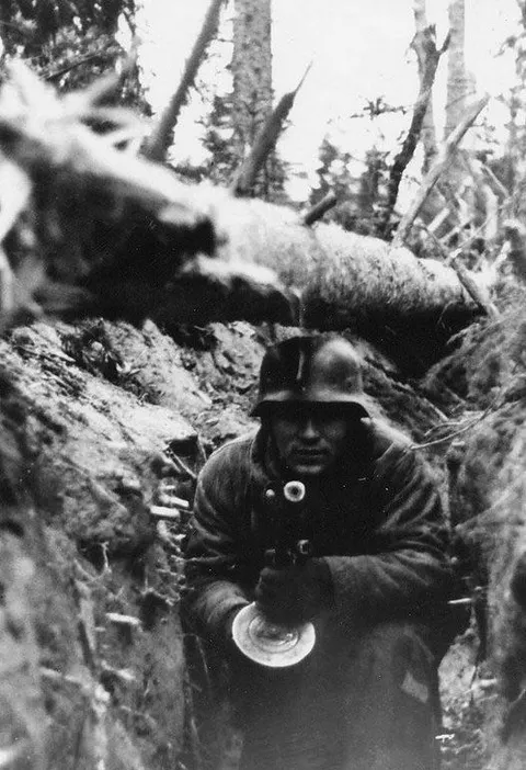 A German soldier in a trench with a captured soviet PPSH-41 submachine gun on the eastern front.