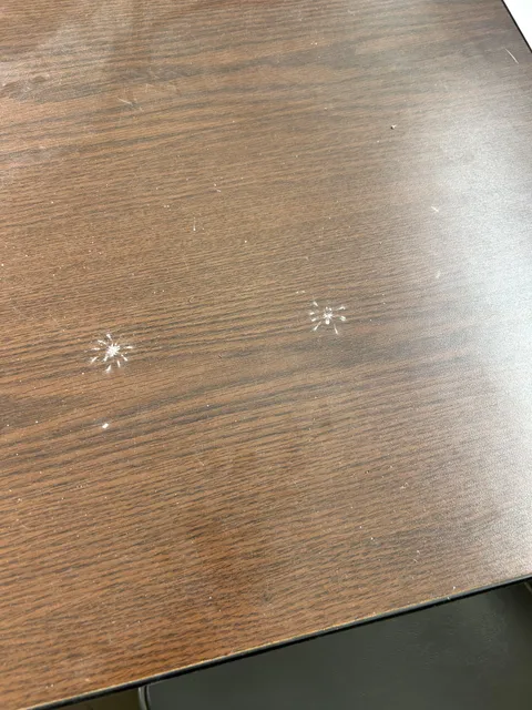 Not one but two spider dust prints on table.