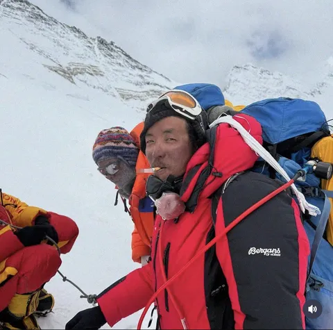 A Sherpa taking a cigarette break at 8,000 meters in the “death zone”, where oxygen is critically scarce