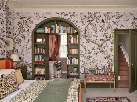 Arched bookcase entrance to the en suite bathroom in the bedroom of a Kensington townhouse, London, UK [2500x1875]