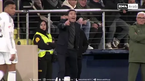 Villarreal manager Marcelino shouting at his players to mark Kylian Mbappé as he stood by next to him, smiling at him.