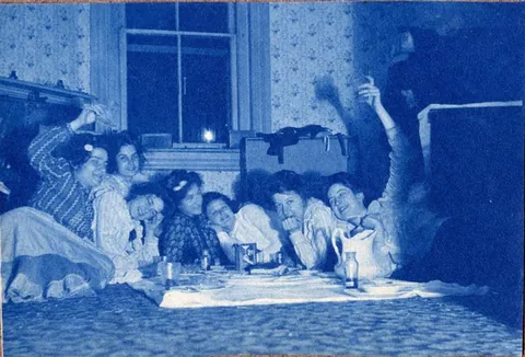 An unnamed young woman recorded her senior year at Asheville Female College in a photo album, Asheville, North Carolina, 1902. It includes a dorm room, group shots of friends, playing in snow, a visit to the mountains, their final midnight party before graduation, and graduation day itself.