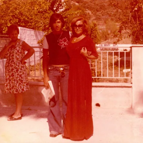 Grandma with my uncle in the 70s (and a random lady judging their outfits)
