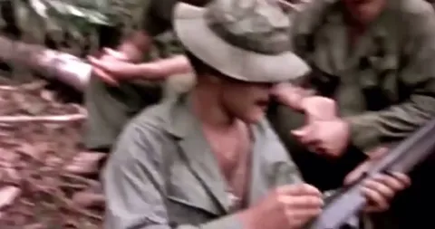 American soldiers in Vietnam smoking Marijuana out of the barrel of a Shotgun, 1970.
