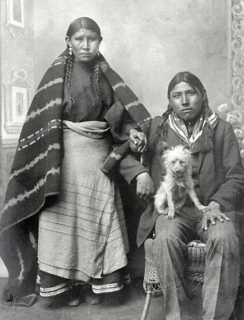 Cheyenne couple, Inez and John Bull, with their dog, 1898