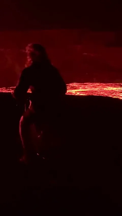 Man and his cameraman drove with bicycle near volcano experienced the raw power and creation...