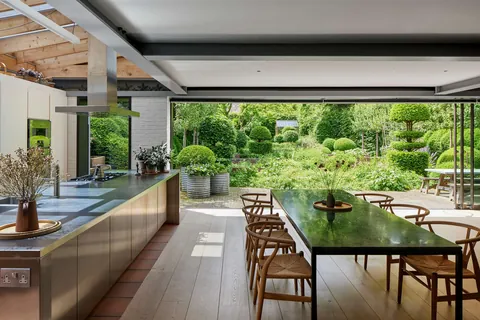 Kitchen and dining space opening up to the lush rear gardens, Whetstone, north London, UK [1600x1067]