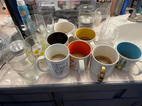 This represents a single week of mugs and glasses that my wife leaves in our bathroom. I clean all of these every week, and they are back the next. Anyone else feel my pain?