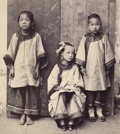 The fate and feet of three Chinese girls - a bare footed slave, a girl with bound feet, and a Christian with unbound feet - ca. early 1900s