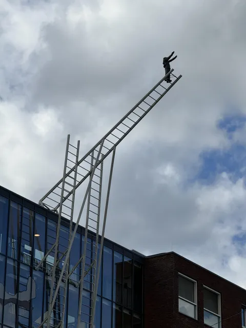 ITAP of a sculpture on the side of a mental hospital.
