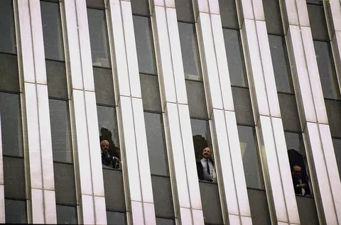 World Trade Center employees look out of broken windows during the 1993 bombing (26 Feb 1993)