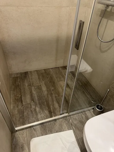 Hotel bathroom floor is just regular floor in the shower.