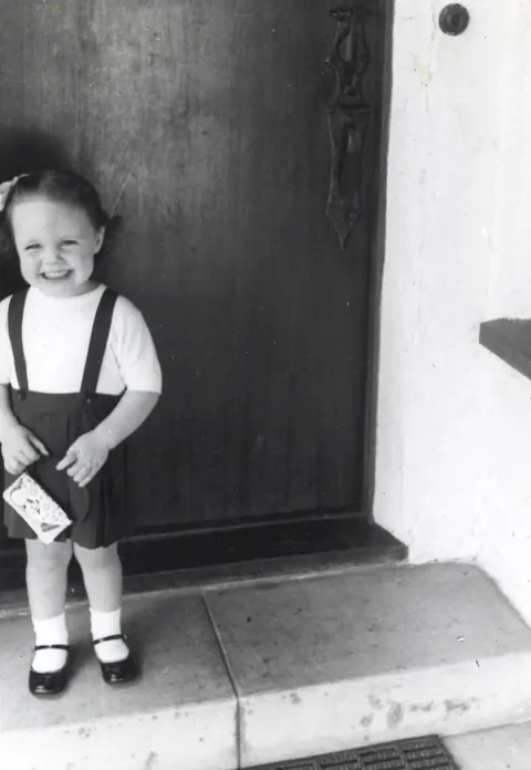 Posing for my grandmother in my fancy new suit. 1957