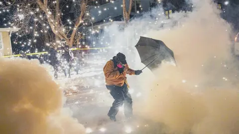 A protester in Minneapolis attempting to protect themselves against munitions and pepper balls