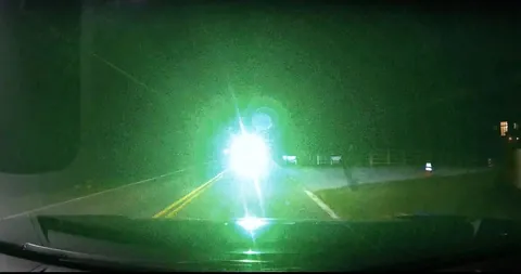 Someone was shining a laser pointer directly into my eyes while driving at night