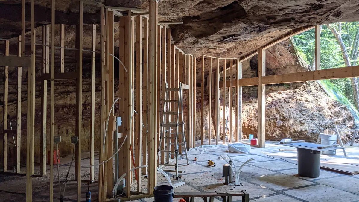 Is building under a huge rock like this safe? My first thought when I say this was earthquakes.