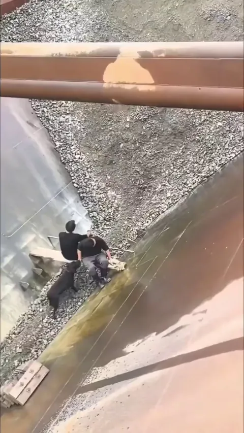 Workers keeping the gravel flowing in a narrow work channel