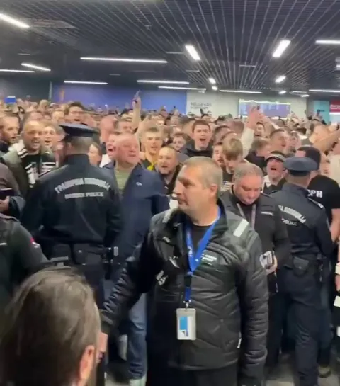 Beloved basketball coach in Serbia resigned after a string of losing games. In response, thousands of fans met him at the Belgrade airport trying to get him to reconsider