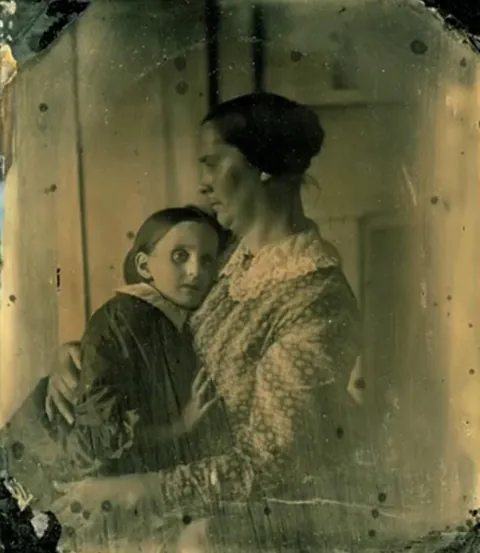 Tintype of a Mother posing with her child, circa 1860-70s.