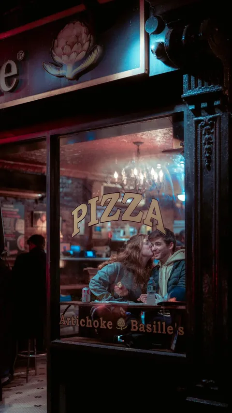 ITAP of a couple at a pizza shop in NYC [Portrait]