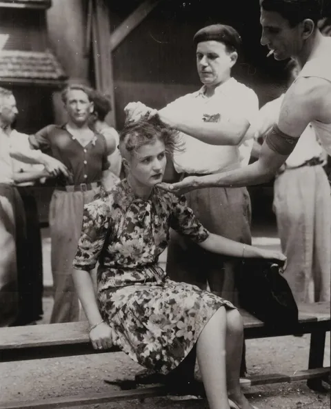 A French woman has her head shaved by civilians as a penalty for collaborating with the nazis during the french occupation 1944