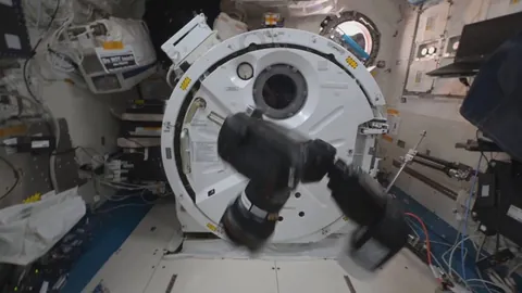 Astronaut Don Pettit demonstrates the Dzhanibekov effect aboard the ISS, where a spinning camera in microgravity unexpectedly flips its rotation axis by 180 degrees.
