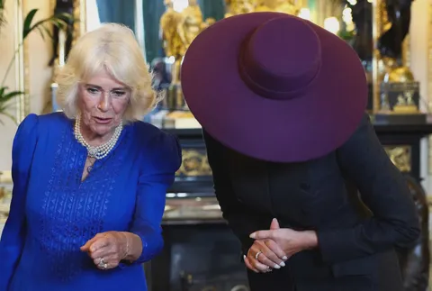 Melania Trump leaves her hat on inside Windsor Castle, unlike the Queen, who removed hers