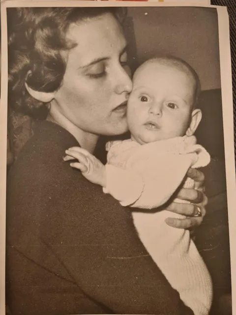 My grandmother (18 y/o) with my mom in 1959