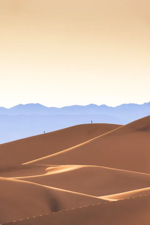 ITAP of two people hiking on sand dunes