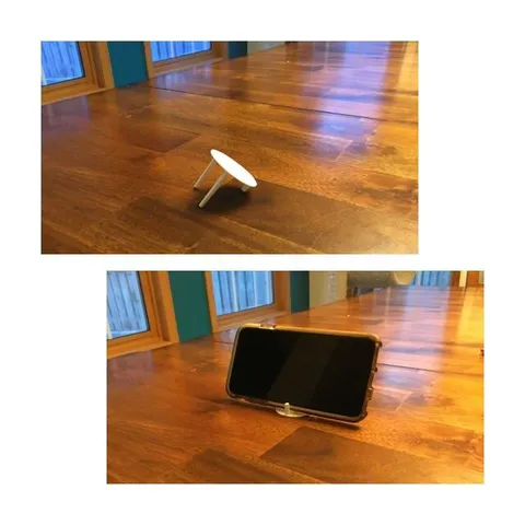 Cut a leg off of a delivery pizza topper thingy to create a smartphone stand