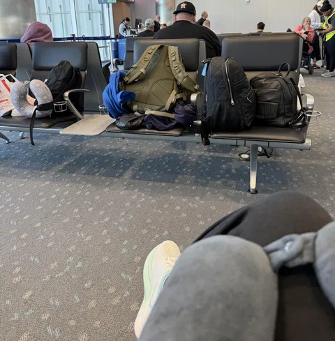 These people are sitting next to me, across from their bags