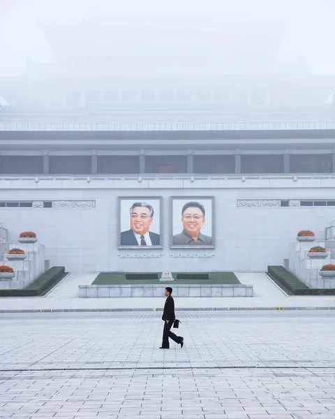 ITAP of a man walking in North Korea [Portrait]