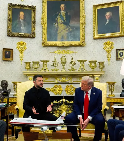 President Zelensky standing out amongst the gold in his all black suit at the White House